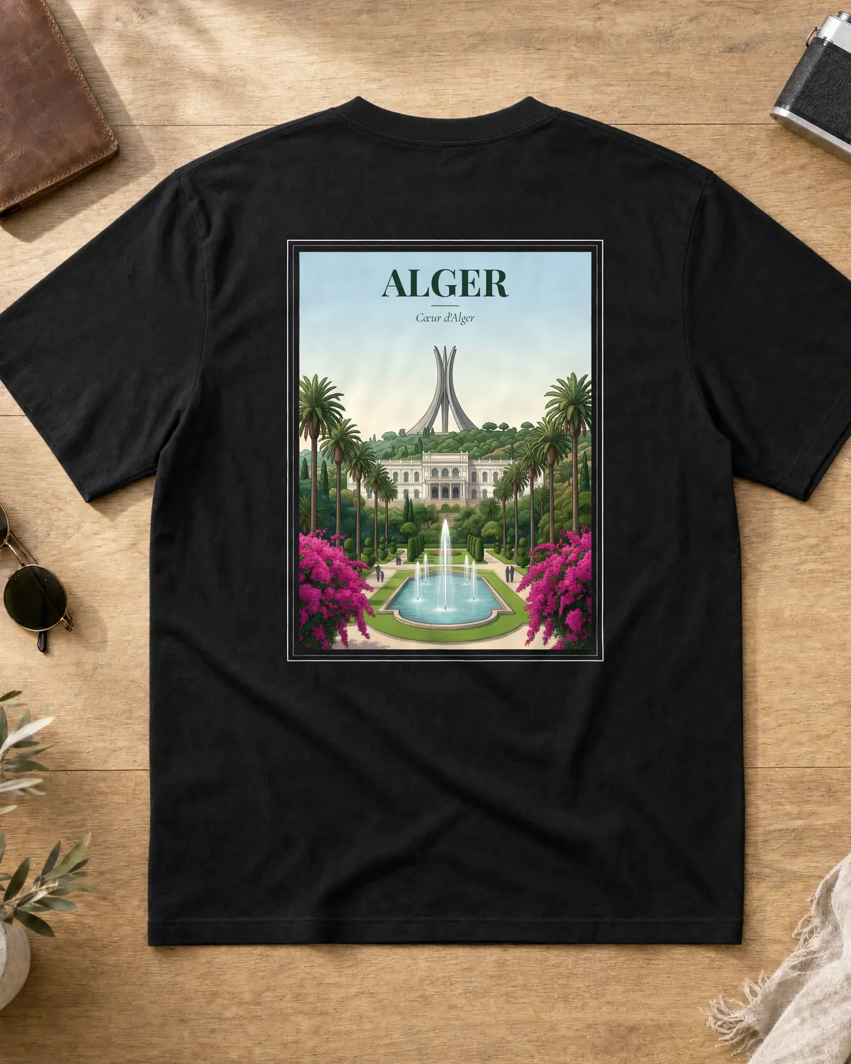 Black Alger t-shirt back with a vintage poster of the Maqam Echahid Martyrs Memorial, fountains, bougainvillea and the tagline Cœur d'Alger