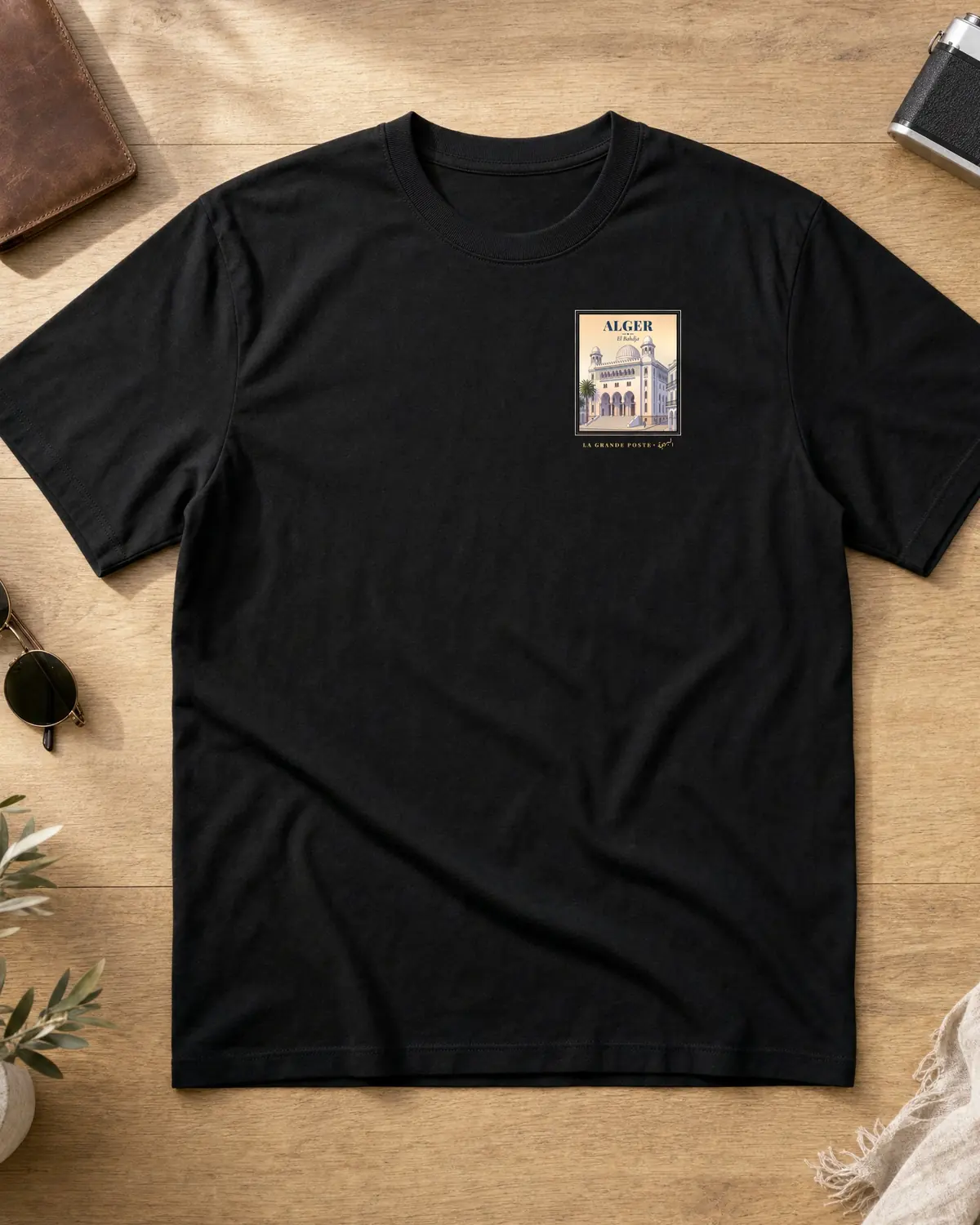 Black t-shirt front with a small Alger Grande Poste poster on the chest