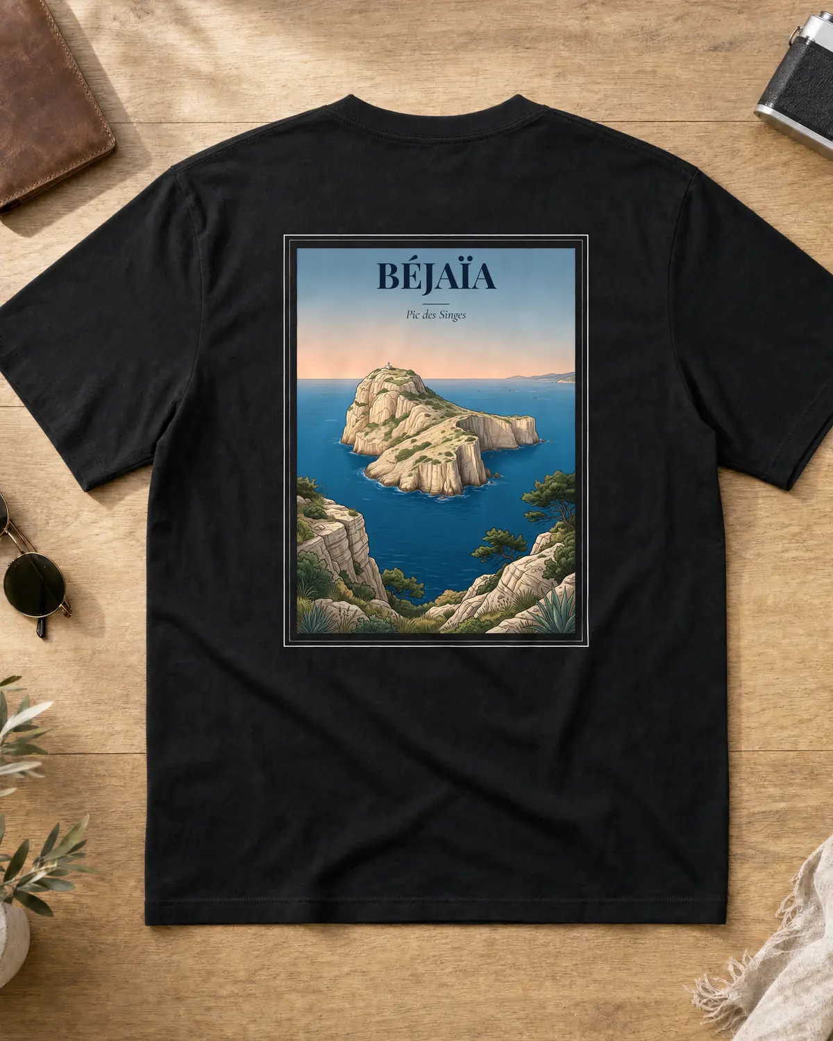 Black Béjaïa t-shirt back with a vintage poster of Pic des Singes (Monkey Peak) rising from the Mediterranean at dawn, with the tagline Pic des Singes