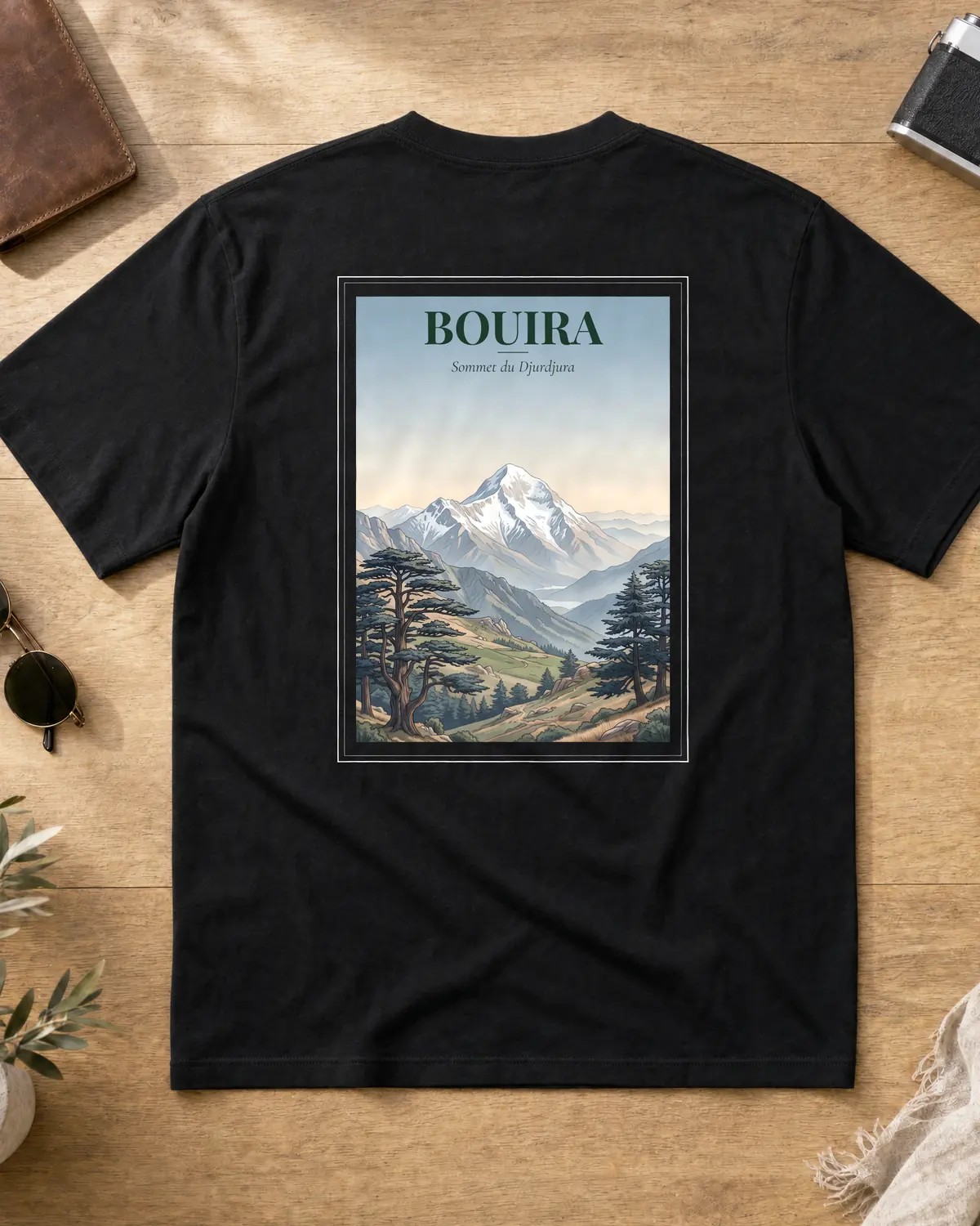 Black Bouira t-shirt back with a vintage travel poster of the snow-capped Djurdjura summit over Kabyle valleys