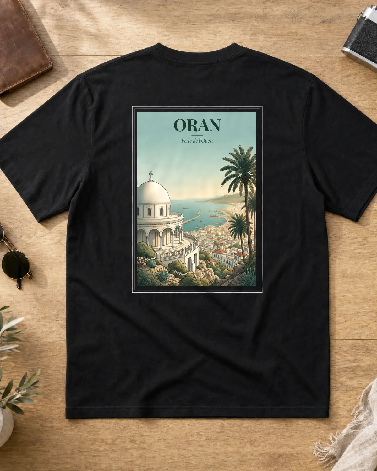 Black Oran t-shirt back with a vintage poster of Santa Cruz church on the cliff over the bay of Oran, a palm tree and the tagline Perle de l'Ouest