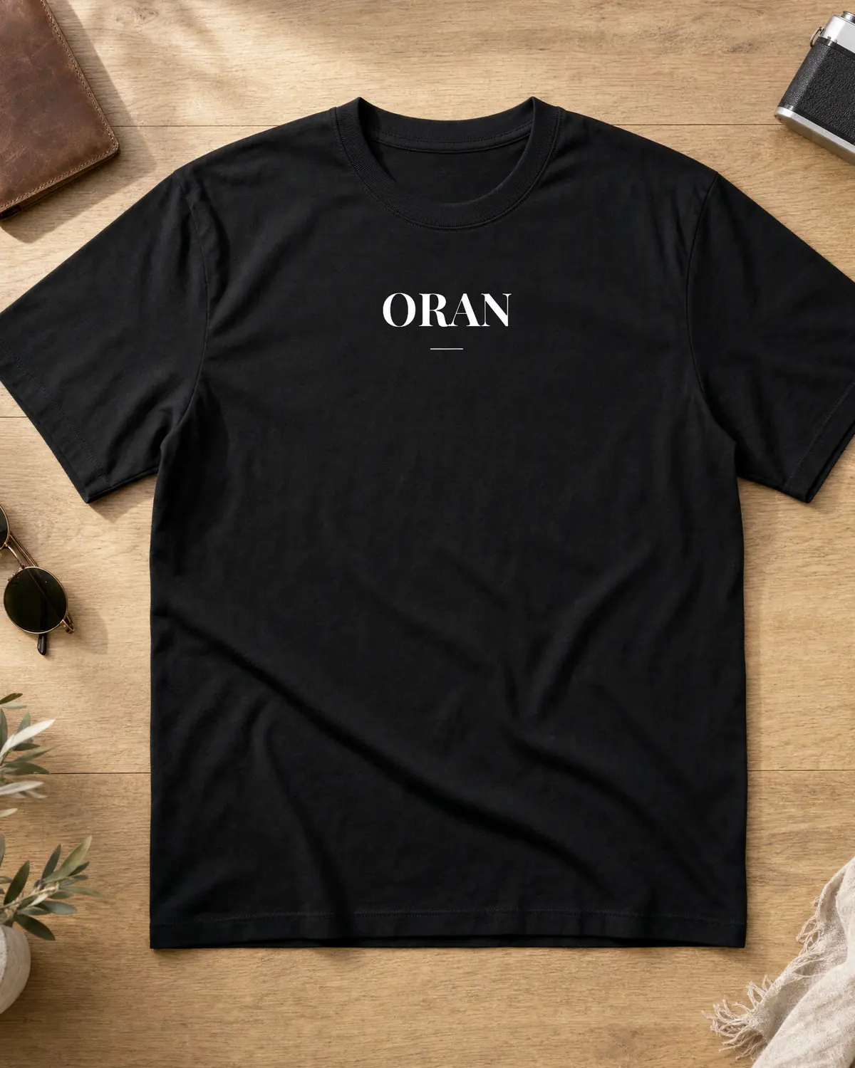 Black Oran t-shirt front with a centered white ORAN wordmark