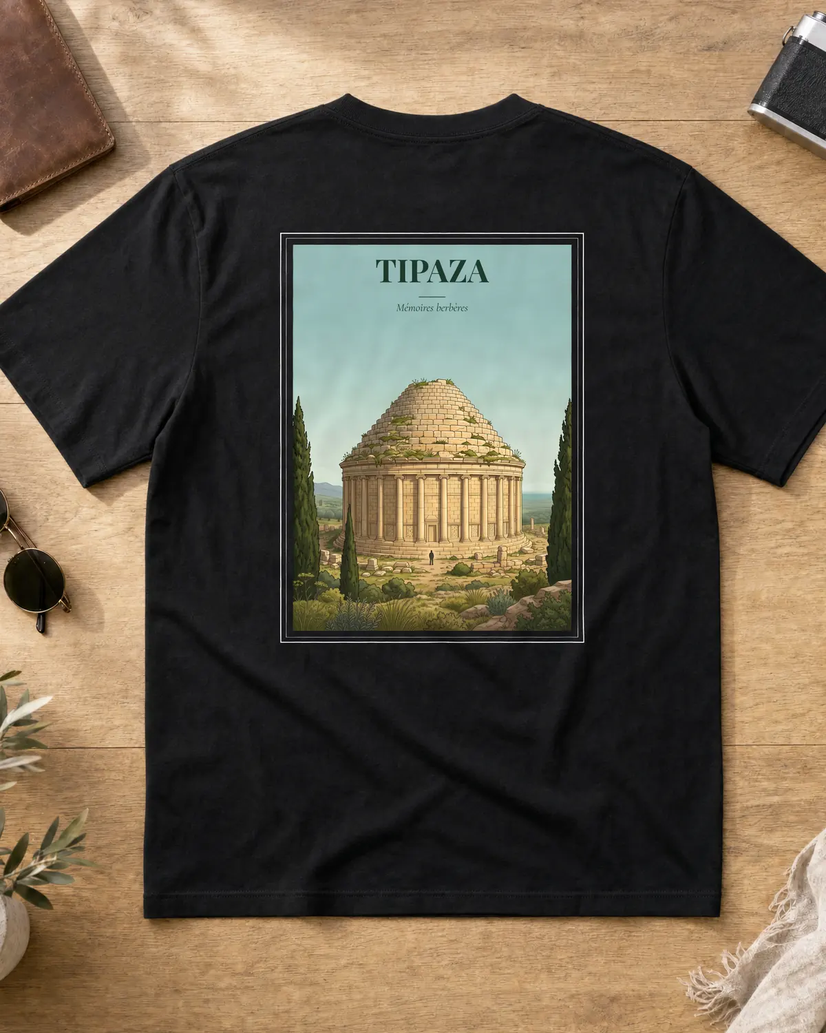 Black Tipaza t-shirt back with a vintage poster of the Royal Mausoleum of Mauretania, cypress trees and the tagline Mémoires berbères