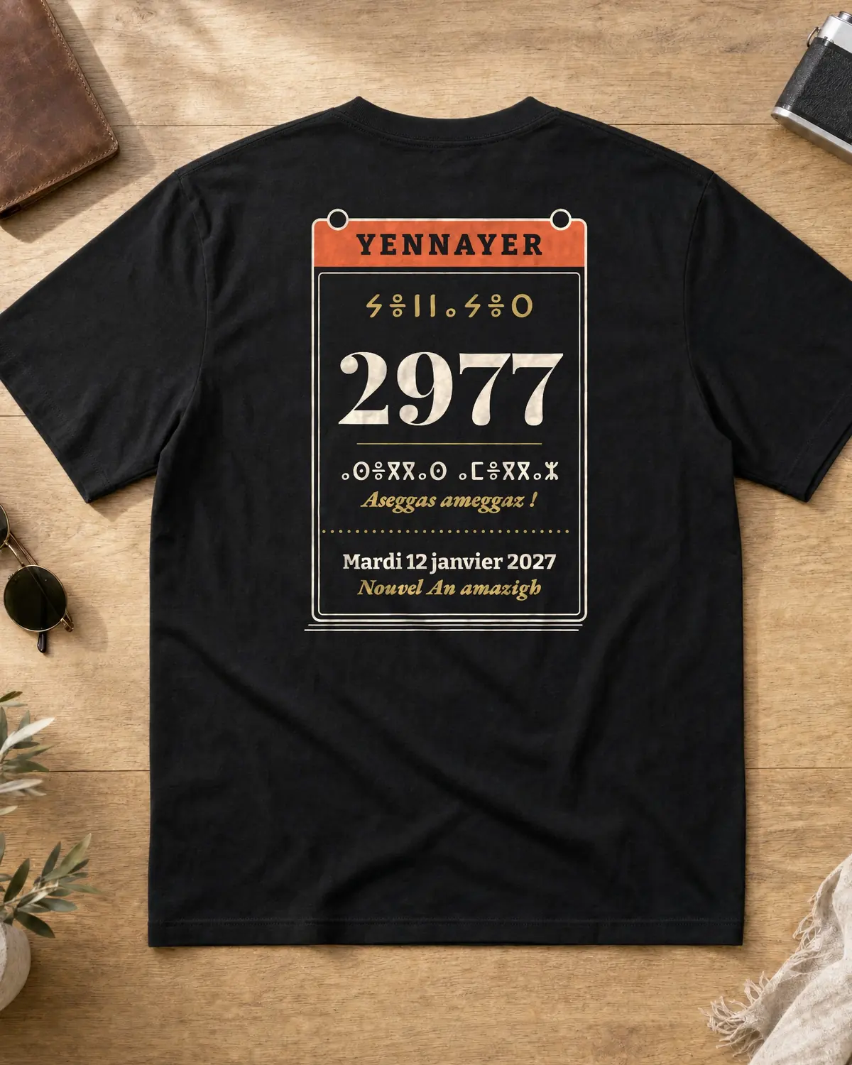 Black t-shirt back with a Yennayer 2977 tear-off calendar page